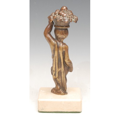 3549 - A 19th century continental bronze figure of a standing putto, balancing a basket of fruit on its hea... 