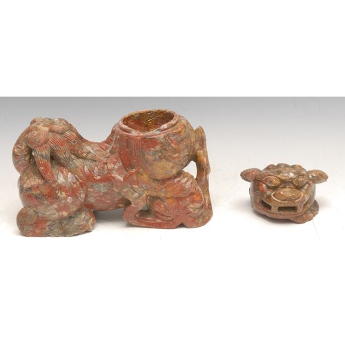 3042 - A Chinese soapstone box and cover of a temple lion or foo dog, baring its teeth and resting its paw ... 