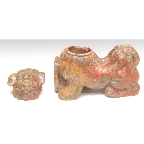 3042 - A Chinese soapstone box and cover of a temple lion or foo dog, baring its teeth and resting its paw ... 