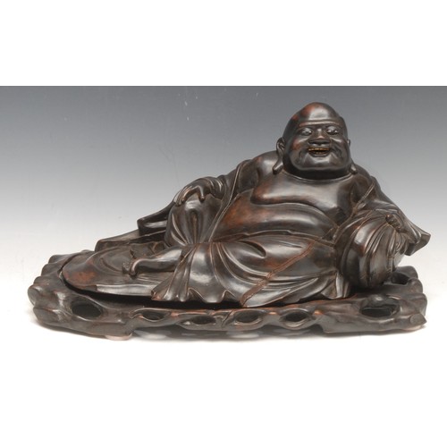 3093 - A large early 20th century Chinese hardwood reclining Buddha, laughing and resting on a cushion, car... 