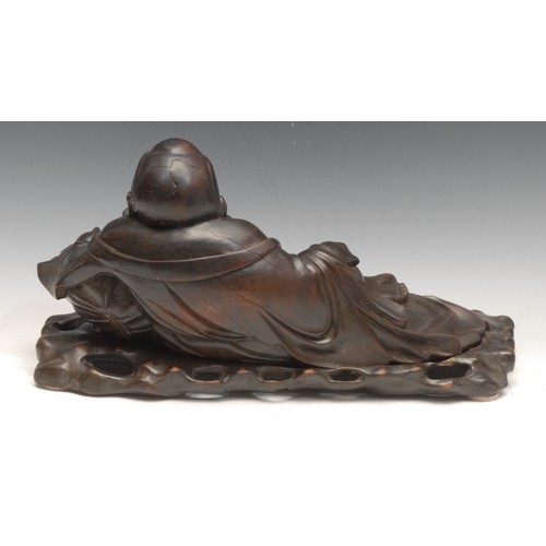 3093 - A large early 20th century Chinese hardwood reclining Buddha, laughing and resting on a cushion, car... 