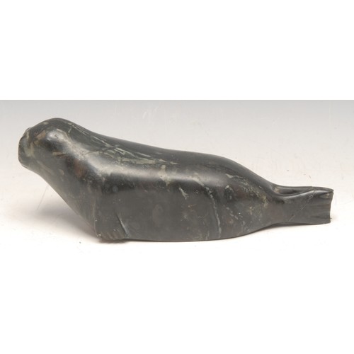 3751 - An Inuit green stone carving, of a seal, inscribed number 1678, 21cm long