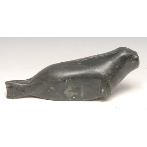 3751 - An Inuit green stone carving, of a seal, inscribed number 1678, 21cm long