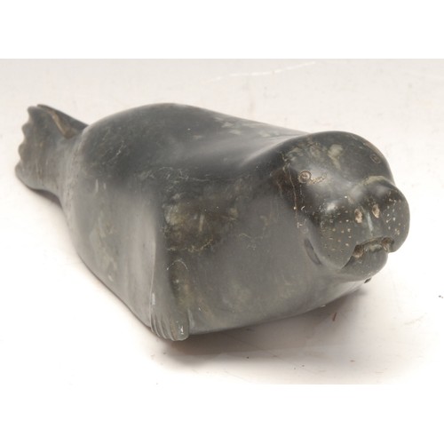 3751 - An Inuit green stone carving, of a seal, inscribed number 1678, 21cm long