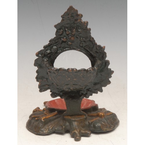 3545 - A 19th century cast iron pocket watch stand, cast with pastoral regalia, 16cm high, c.1860