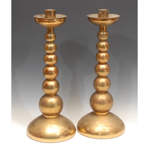 3159 - A pair of large brass candlesticks, graduated bobbin stems, removable wax tray, each 42cm high (2)