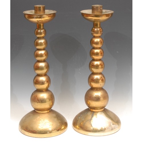 3159 - A pair of large brass candlesticks, graduated bobbin stems, removable wax tray, each 42cm high (2)