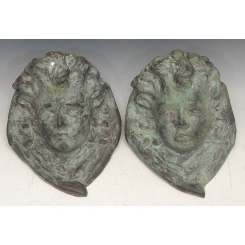 3132 - A pair of 19th century bronze wall brackets, cast as putti, each 20cm high, 19cm wide