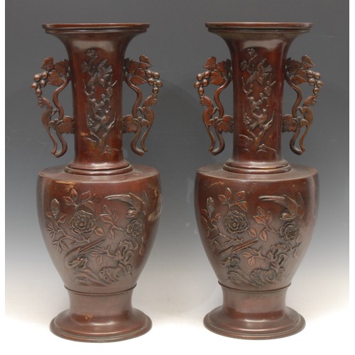 3161 - A pair of large Meiji period Japanese bronze vases, of footed urn form with sleeve necks and applied... 