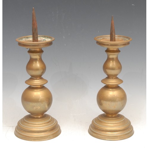 3166 - A pair of short 19th century Continental brass pricket candlesticks, knopped stems, stepped circular... 