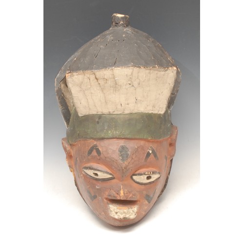 3781 - Tribal Art - a Yoruba gelede helmet mask, decorated in red, black and white pigments, 23cm high, Nig... 