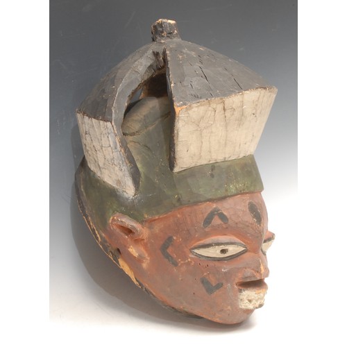 3781 - Tribal Art - a Yoruba gelede helmet mask, decorated in red, black and white pigments, 23cm high, Nig... 