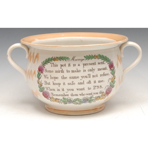 3328 - An English lustre pottery marriage chamber pot, printed with verse, the interior with caricature and... 