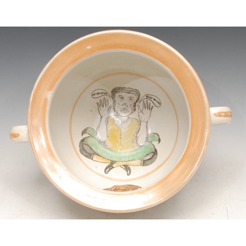 3328 - An English lustre pottery marriage chamber pot, printed with verse, the interior with caricature and... 