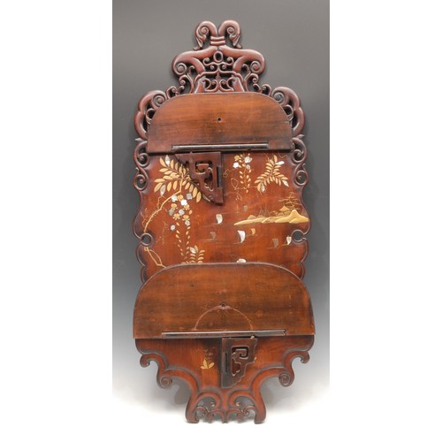 3034 - A Chinese hardwood wall shelf, shaped and pierced cresting above two folding tiers, decorated in gil... 