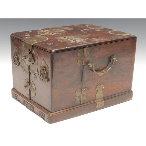 3033 - A Chinese hardwood rounded rectangular dressing box, hinged folding cover enclosing an arrangement o... 