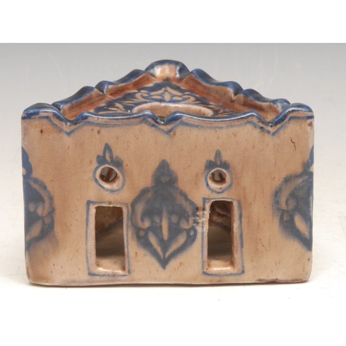 3114 - A Middle Eastern tin glazed earthenware triform inkwell, in the Islamic taste, 12cm wide