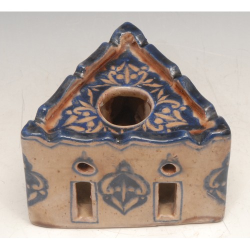 3114 - A Middle Eastern tin glazed earthenware triform inkwell, in the Islamic taste, 12cm wide