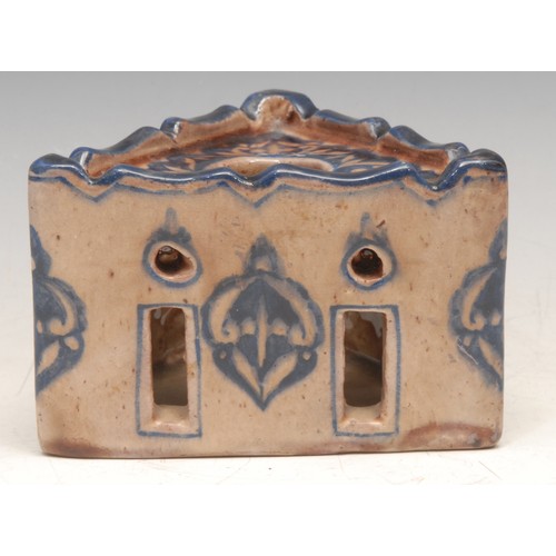 3114 - A Middle Eastern tin glazed earthenware triform inkwell, in the Islamic taste, 12cm wide