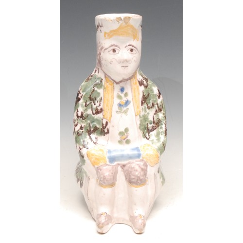 3062 - A French faience Toby jug, modelled as a seated man, 24.5cm high, late 19th century