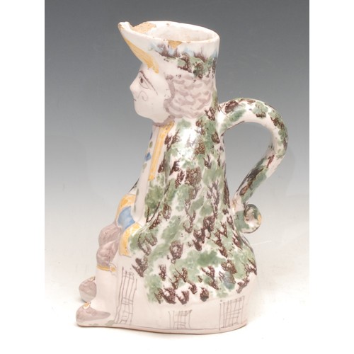 3062 - A French faience Toby jug, modelled as a seated man, 24.5cm high, late 19th century