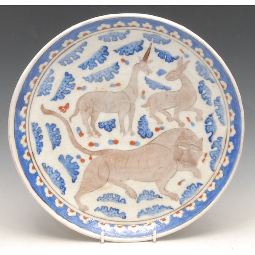 3648 - A Middle Eastern circular charger, decorated in the Persian Islamic taste, with stylised animals, 30... 