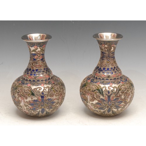 3715 - A pair of Chinese cloisonné bottle vases, the raised silver wire applied with scrolling foliate shap... 