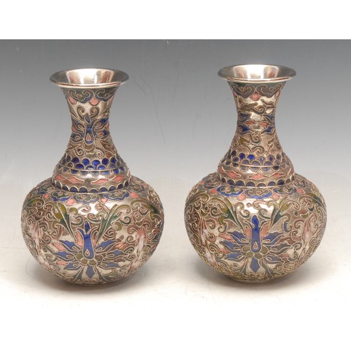 3715 - A pair of Chinese cloisonné bottle vases, the raised silver wire applied with scrolling foliate shap... 