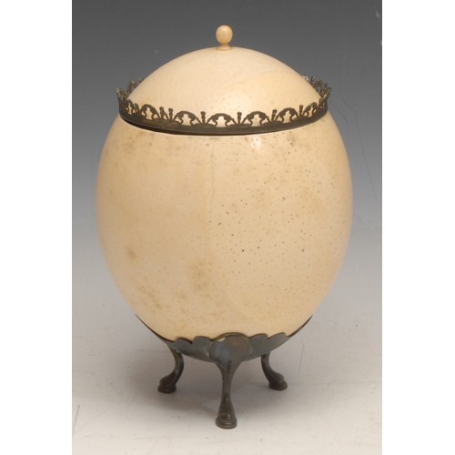 3835 - The Wunderkammer - an ostrich egg cup and cover, hoof feet, 19cm high