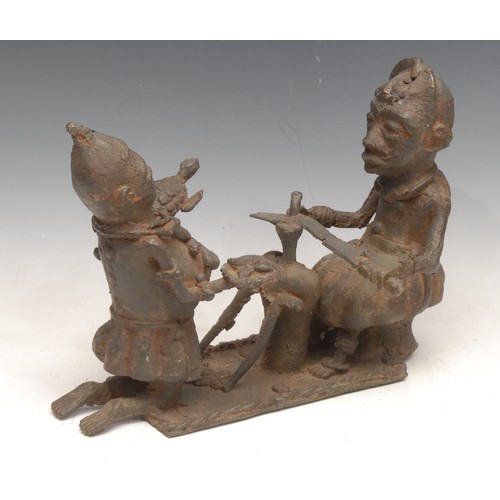 3760 - Tribal Art - a Benin bronze figure group, a sword-maker and companion, 26cm wide