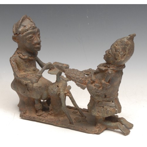 3760 - Tribal Art - a Benin bronze figure group, a sword-maker and companion, 26cm wide