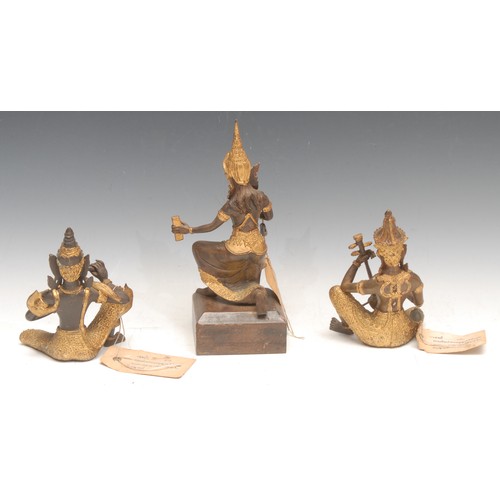 3196 - A set of three figures, cast as Buddhas, one plays the veena, the largest 23cm high overall, Thailan... 