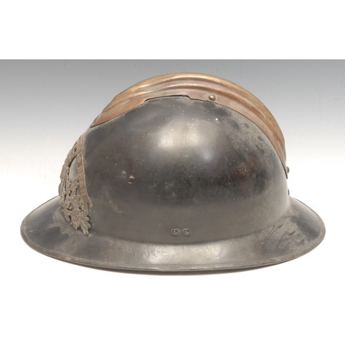 3385 - Fire Brigade History - an early 20th century French brass mounted and black painted fireman's helmet... 