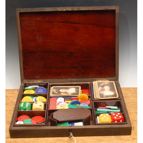 3571 - A 19th century French lacquered games box, the brass inlaid hinged cover revealing an assortment of ... 