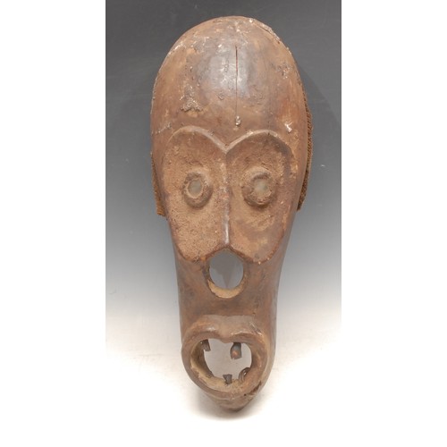 3790 - Tribal Art - an Ogoni mask, concave features, glass eyes, 46cm high, Nigeria