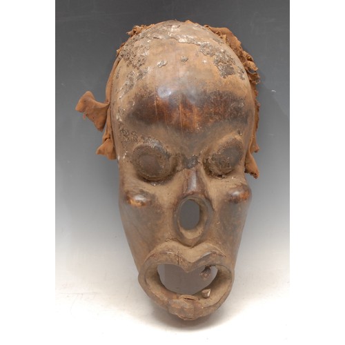 3788 - Tribal Art - an Ogoni mask, concave features, glass eyes, 37cm high, Nigeria