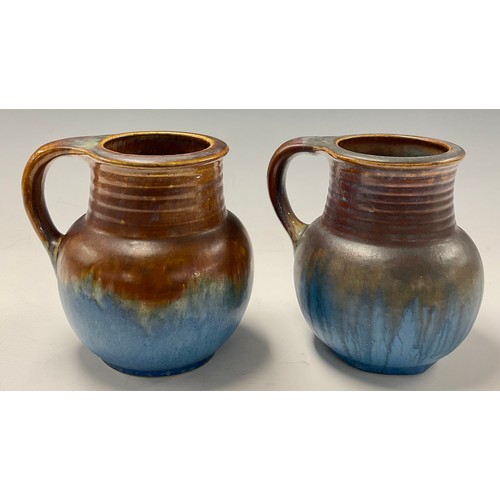 29 - A matched pair of Bourne Denby Danesby Ware Orient Ware Chevin shaped single handled vases, ribbed n... 