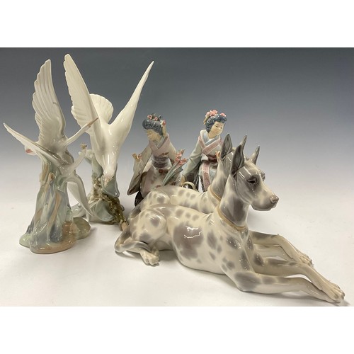 33 - A Lladro model, of a Great Dane, 30.5cm long; another; a Lladro model, of a Dove in flight, 29cm hig... 