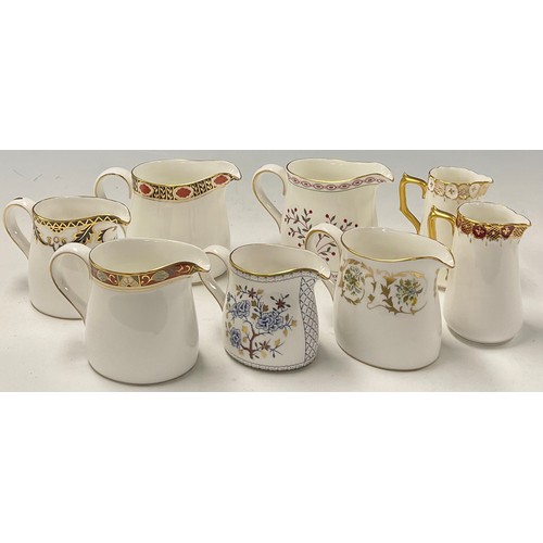 38 - A collection of Royal Crown Derby cream jugs, various shapes, including Mikado, Blue Aves, Red Aves,... 