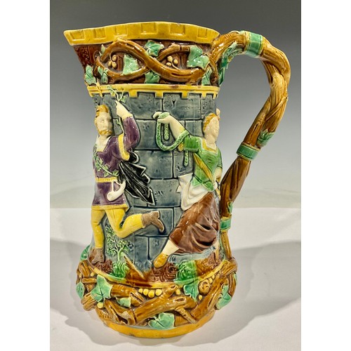 64 - A Minton majolica 'tower' jug, relief moulded with medieval dancers, naturalistic vine handle, 24cm ... 