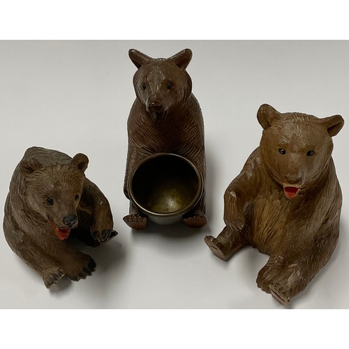 65 - A Black Forest novelty pin dish, carved as a bear holding a brass bowl; others (3)