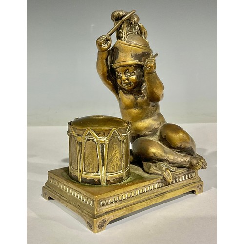 68 - An early 20th century bronze novelty inkwell, as a putto beating a drum