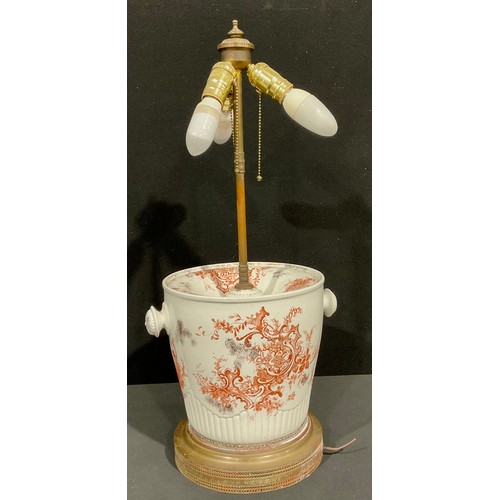 69 - Interior Decoration - an unusual brass mounted porcelain table lamp, modelled from a 19th century sl... 