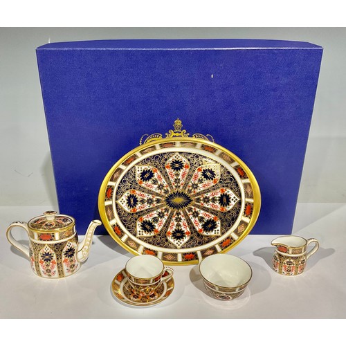 70 - A Royal Crown Derby Imari palette 1128 pattern miniature tea set on oval tray, first quality, boxed