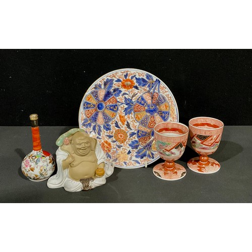 94 - A Japanese Imari plate; two Kutani wine goblets; a long necked vase and budai holding a lotus (5)