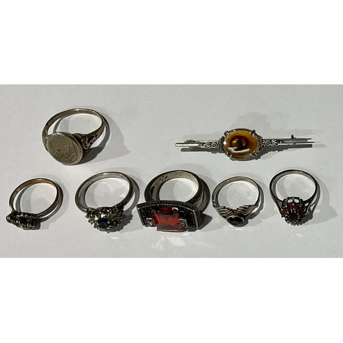 98 - A silver armorial ring; five silver rings; a silver brooch