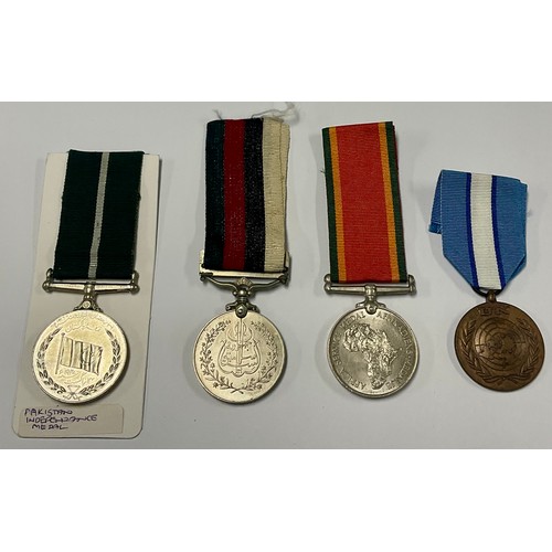 193 - Medals - A South Africa Service medal; a UN medal; Pakistan Independance; another