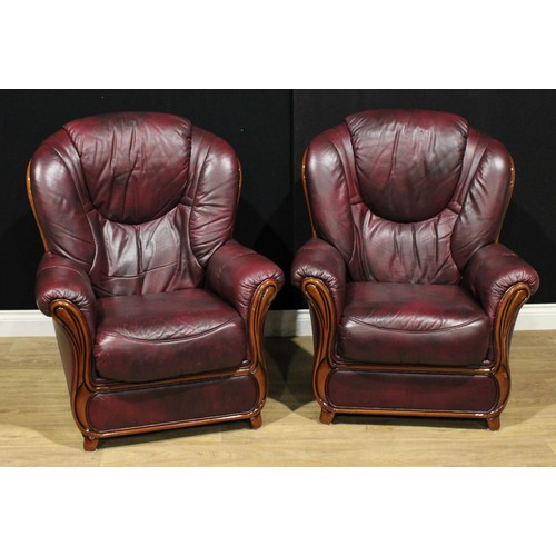 122 - A pair of leather armchairs, 104cm high, 84cm wide, the seat 45cm wide and 51cm deep (2)