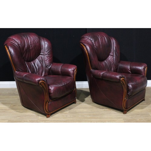 122 - A pair of leather armchairs, 104cm high, 84cm wide, the seat 45cm wide and 51cm deep (2)