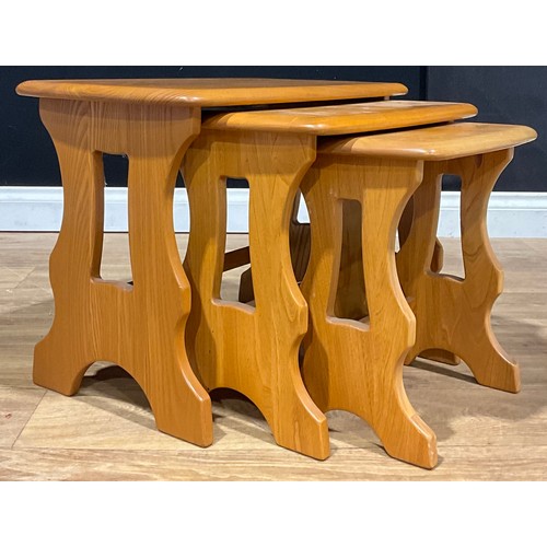 212 - An Ercol Chantry elm nest of three occasional tables, model 498, the largest 42cm high, 56.5cm wide,... 